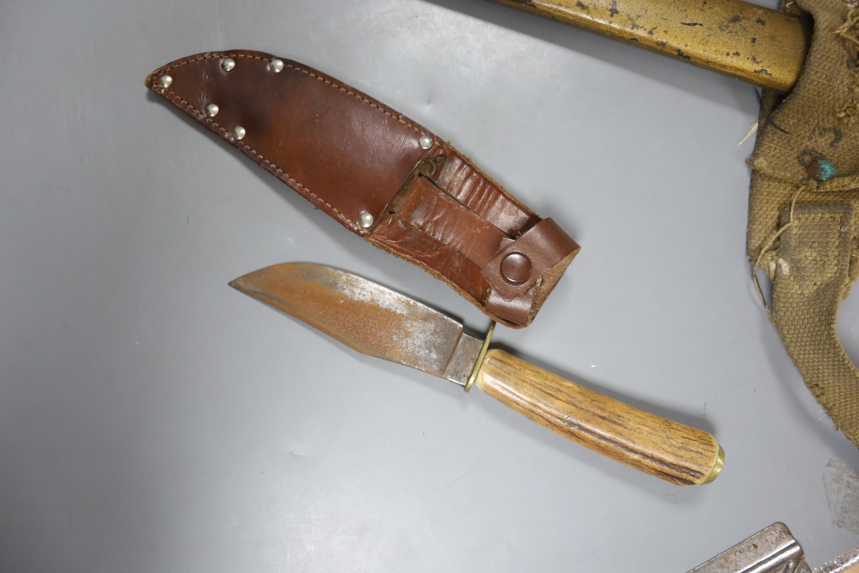 A bayonet with scabbard and a knife, bayonet 71 cms long.